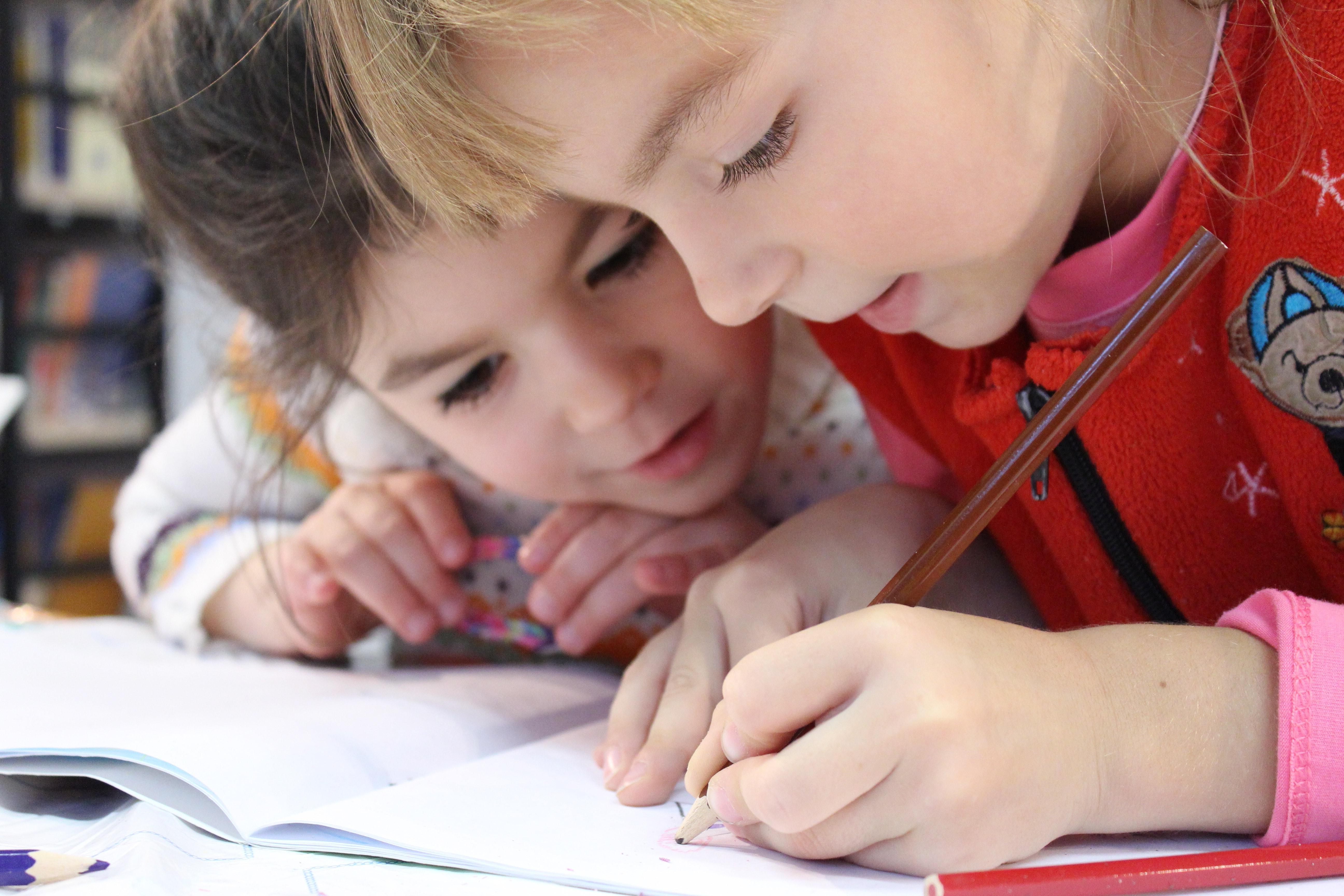 sspac/two children working together on a homework assignment